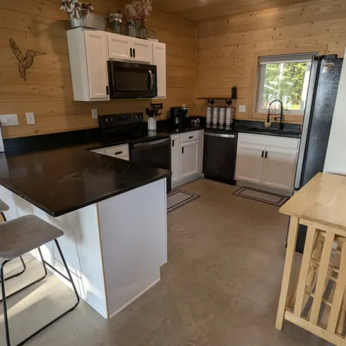 Recessed lighting and modern cabinetry in our fully stocked kitchen, creating a bright and inviting space for cooking at the lakehouse.