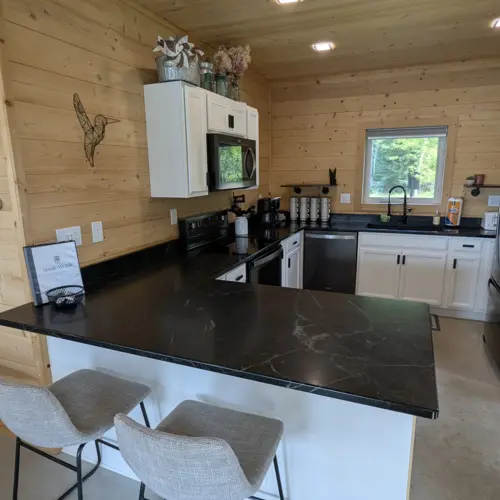 Large granite countertops and modern sink at Smile Awhile, providing plenty of space for preparing large family meals in Eagle River.