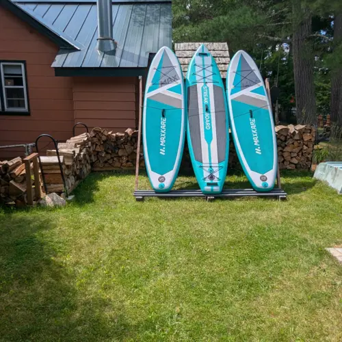 Complimentary kayaks, canoes, and paddle boards available for guests at Smile Awhile, perfect for exploring the calm waters of Eagle River.